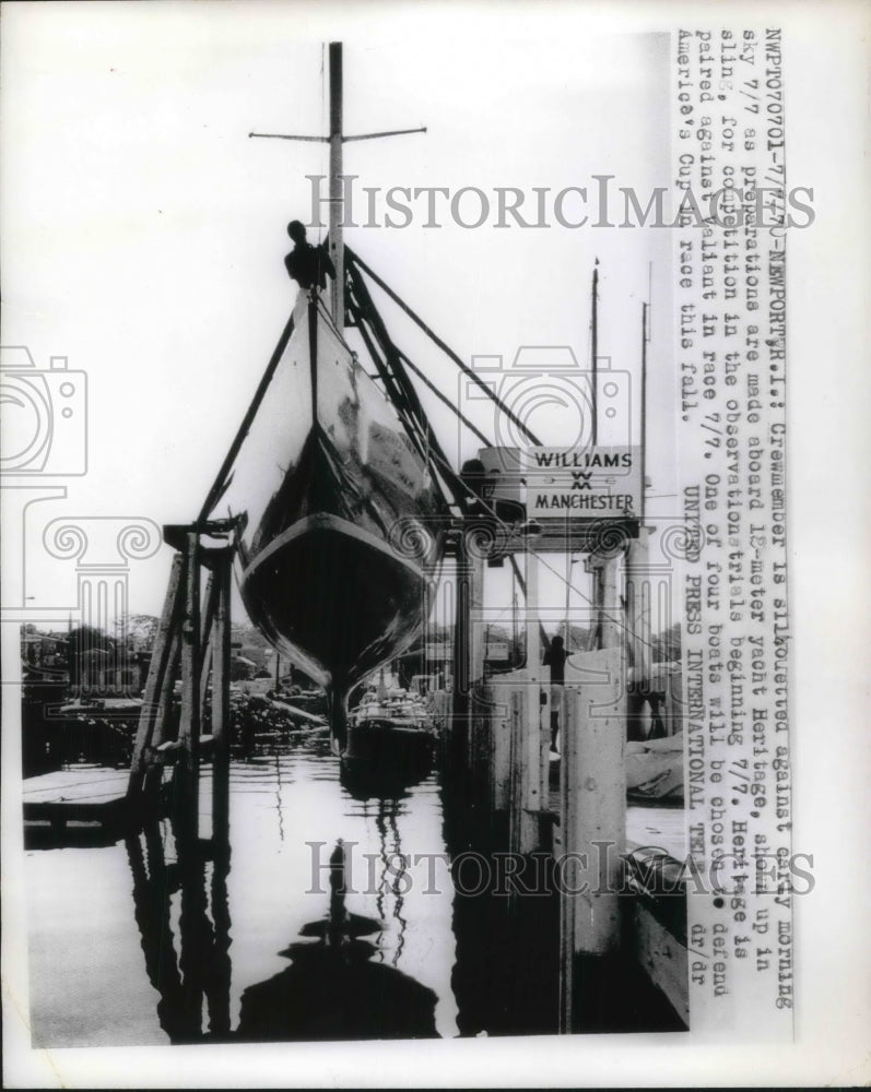 1970 Press Photo Crew Member Silhouetted Against Sky During Preparations- Historic Images