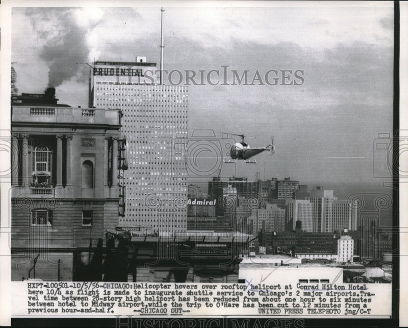 Load image into Gallery viewer, 1956 Press Photo Helicopter Hovers Over Rooftop of Conrad Hilton Hotel
