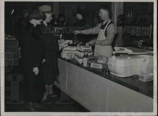 1937 Press Photo Grocer William T. Price Tests the Voluntary Transaction Tax- Historic Images