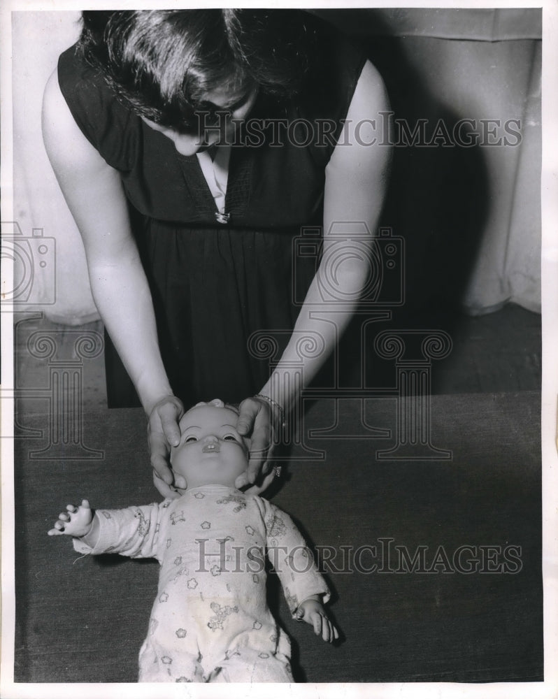 1957 Press Photo Brooklyn Red Cross Worker Demonstrates CPR on Infant- Historic Images