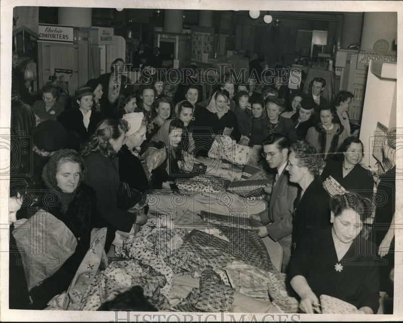 Load image into Gallery viewer, Press Photo Group of Women Looking Over Fabric in Unknown Location
