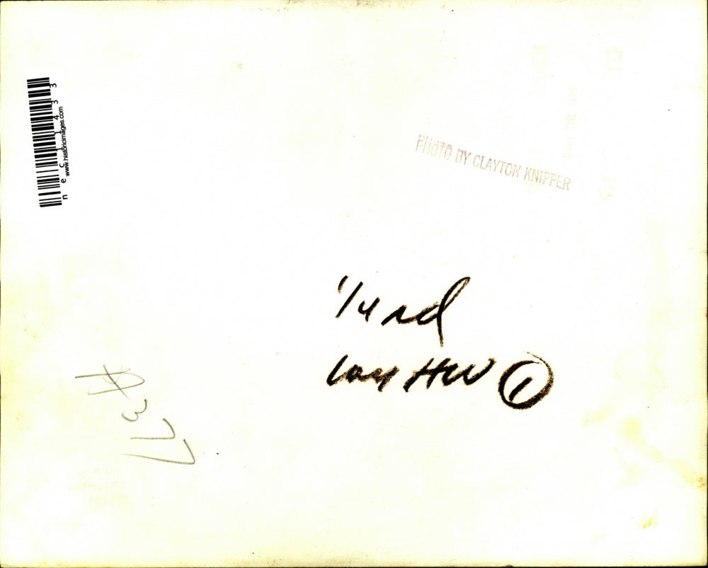Press Photo Group of Women Looking Over Fabric in Unknown Location