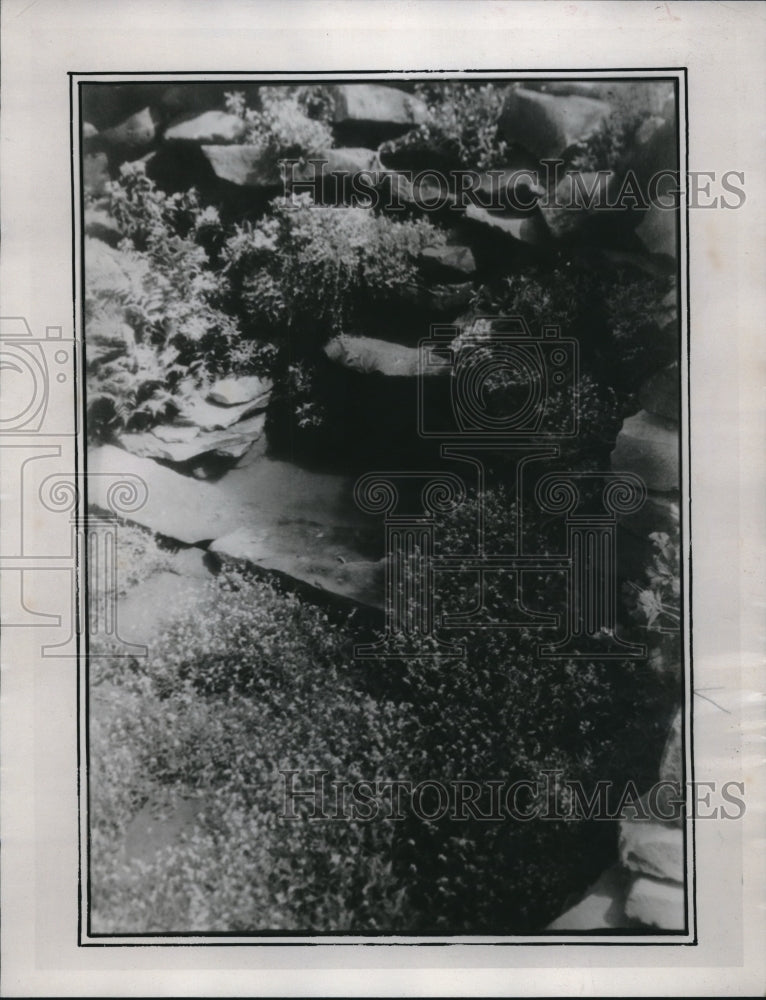 1935 Press Photo Scenic Landscaped Water Pond Overflowing Into Rock Garden