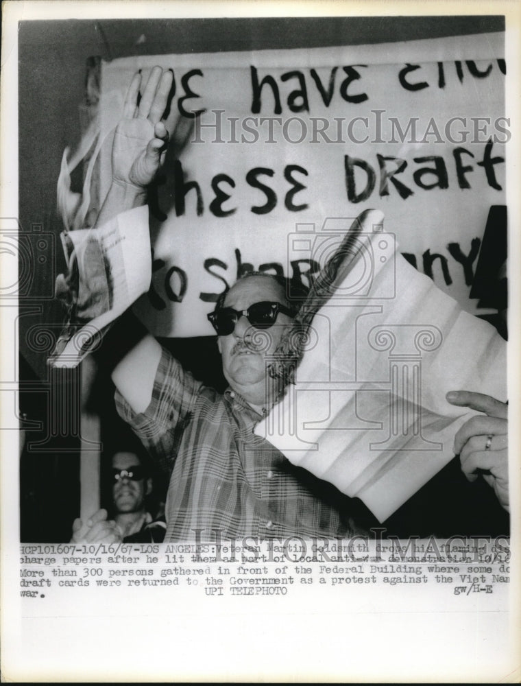 1967 Press Photo Martin Goldsmith drops his flaming discharge papers- Historic Images