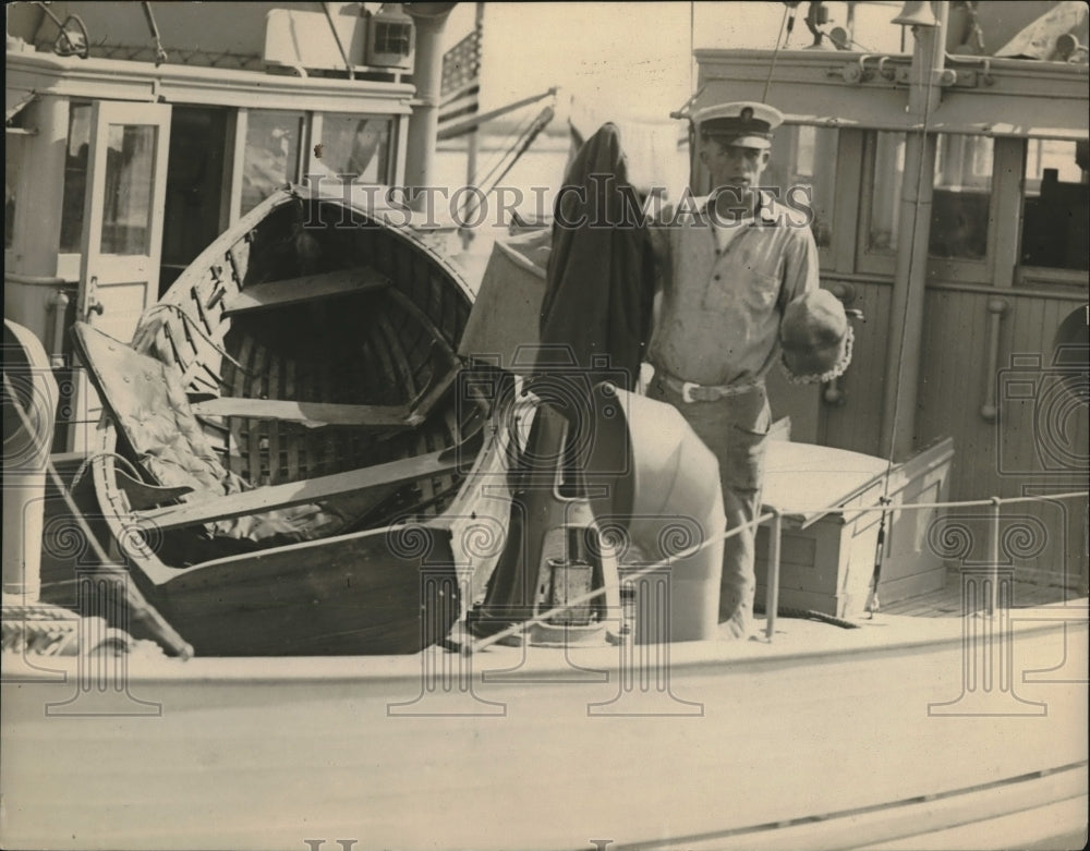 1925 Press Photo Man Holds Recovered Wreckage From Explosion Of Crystal Boat- Historic Images