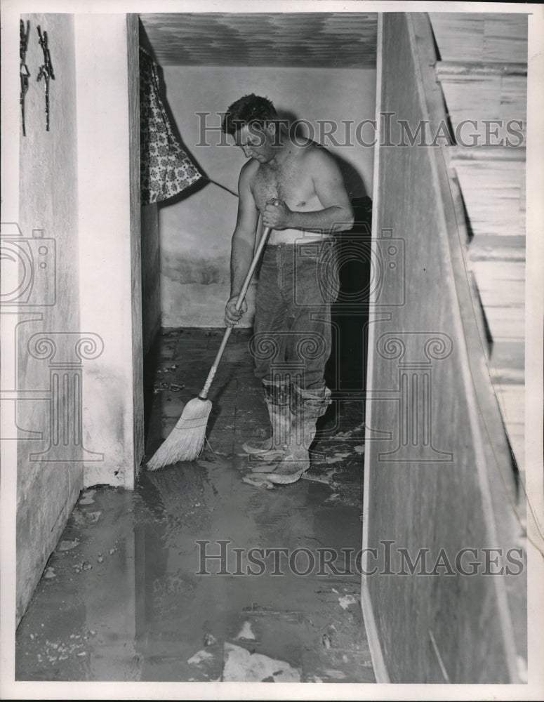 1957 Press Photo Edward Murphy Sweeps Flooded Water &amp; Mud From Basement- Historic Images