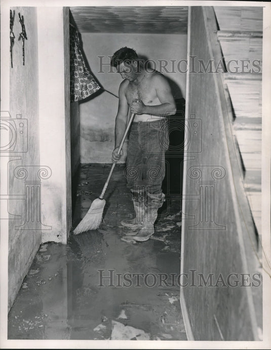 1957 Press Photo Edward Murphy Sweeps Flooded Water & Mud From Basement- Historic Images