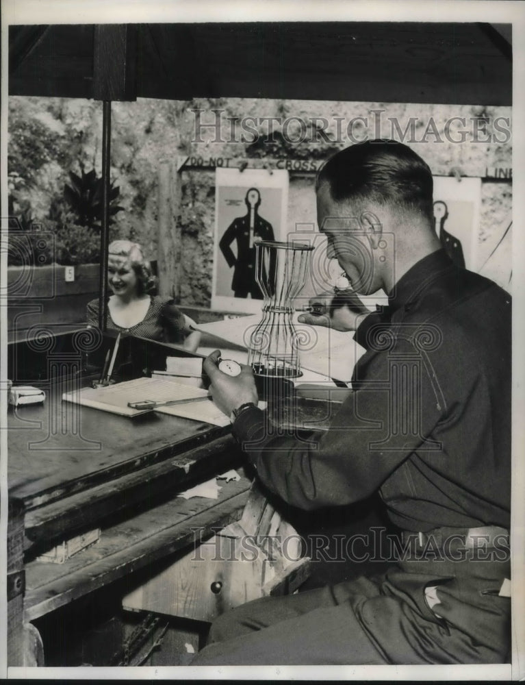 Load image into Gallery viewer, 1940 Press Photo Score Keeper Checks Time During Shooting Match
