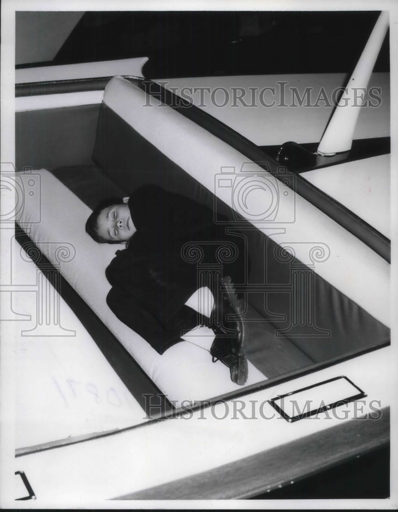 Load image into Gallery viewer, 1961 Press Photo 11 Year Old Arthur Schow Falls Asleep At Detroit Boat Show
