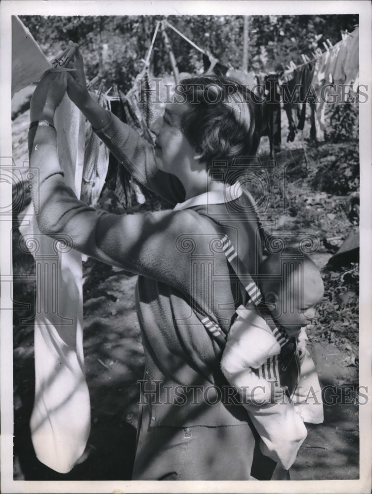1957 Press Photo James Lash & Mother Mrs. Michael Lash As She Hangs Out The Wash
