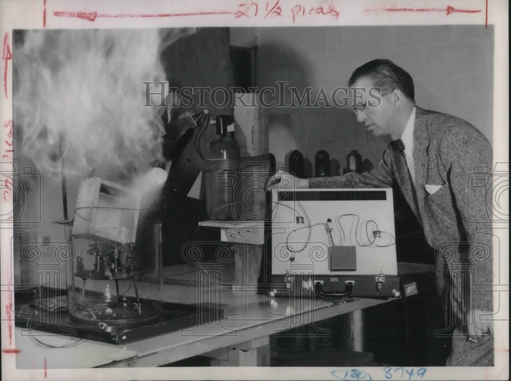 1953 Press Photo Robert Postal demonstrates device to minimize fire hazard
