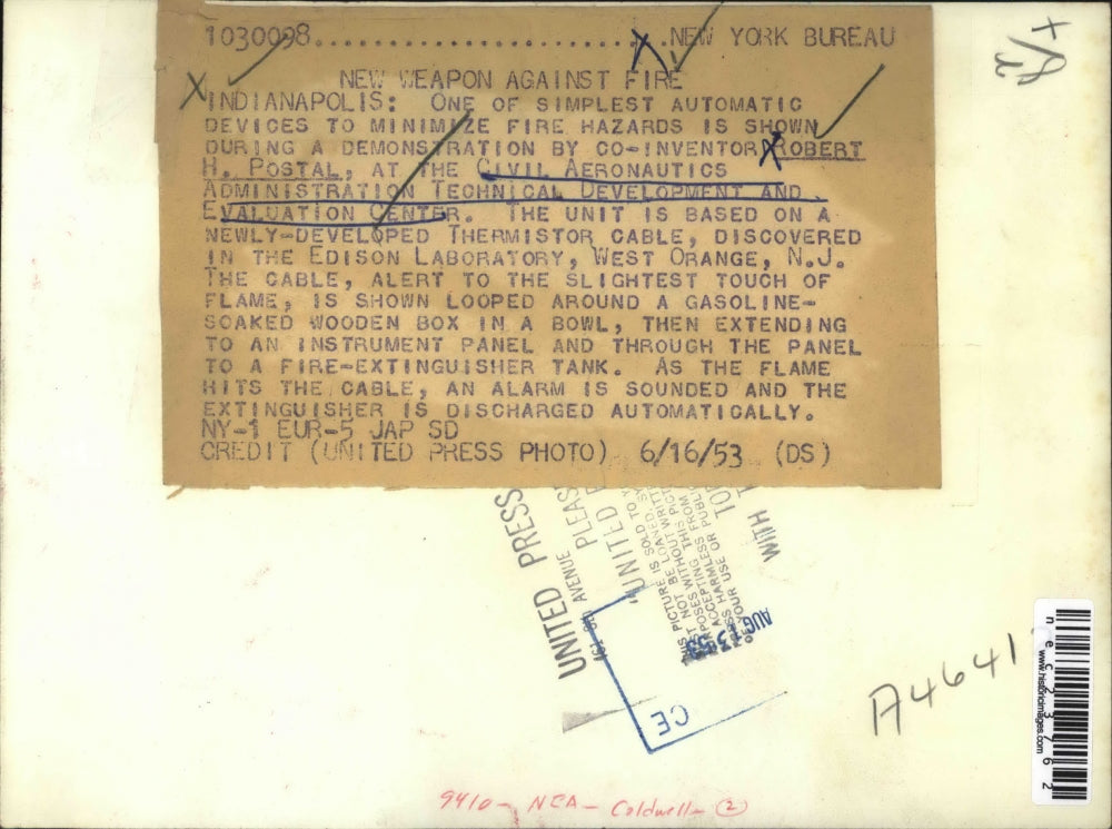 1953 Press Photo Robert Postal demonstrates device to minimize fire hazard