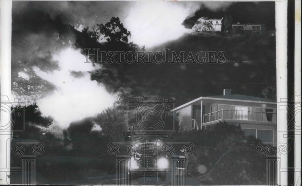 1956 Press Photo 2 homes on Ramblo Pacifico Rd. surrounded by flames - nec24400