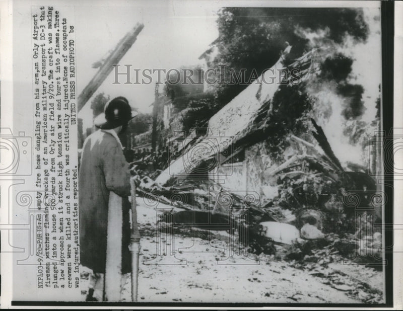 Load image into Gallery viewer, 1952 Press Photo Fireman Watches Wreckage Of DC-3 Plane At Orly Air Field
