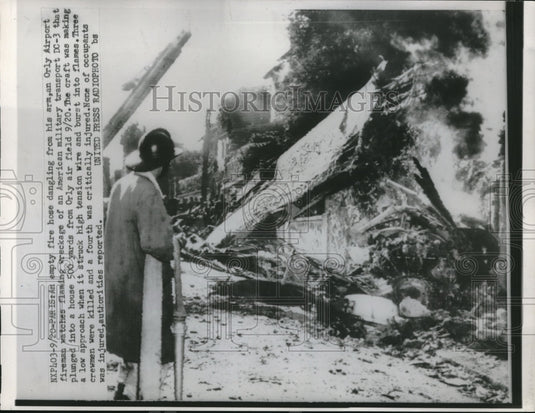 1952 Press Photo Fireman Watches Wreckage Of DC-3 Plane At Orly Air Field