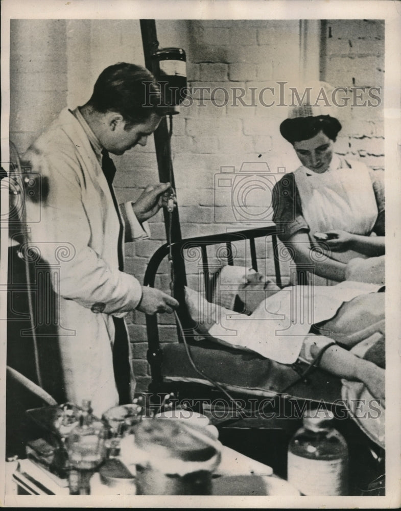 Load image into Gallery viewer, 1941 Press Photo English Air Raid Victim Receiving Blood Transfusion
