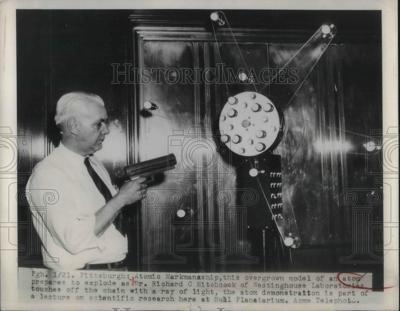 Load image into Gallery viewer, 1949 Press Photo Dr. Richard C. Hitchcock with model of an atom.
