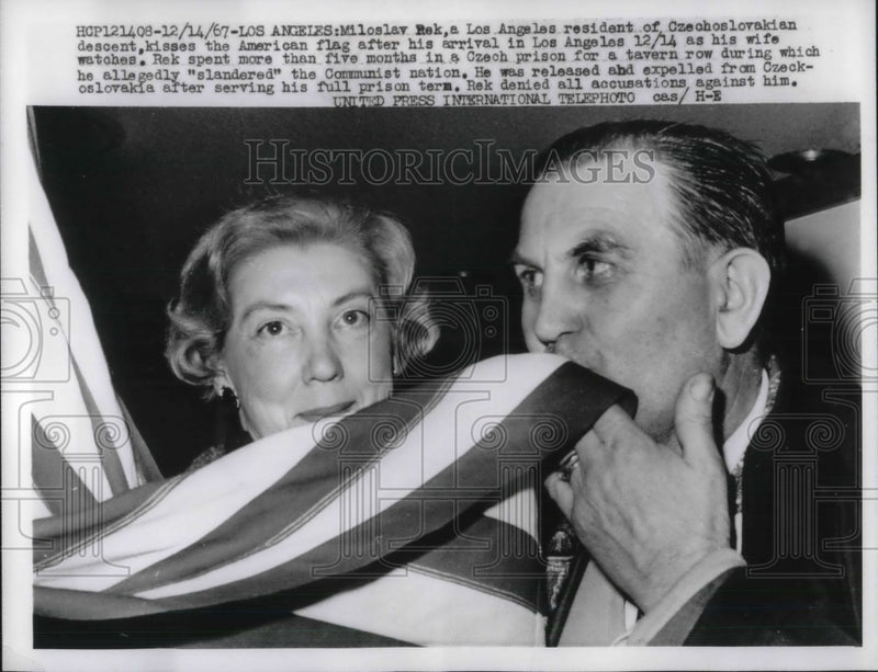 Load image into Gallery viewer, 1967 Press Photo Miloslay Rek Kisses the American flag after arrival in LA
