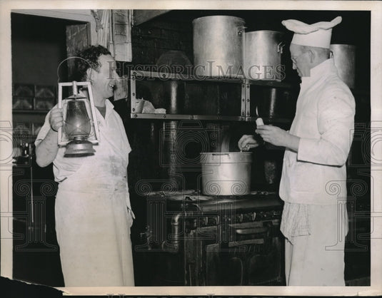 1937 Press Photo Check Cooking By Candle After Welfare Island Darkened by Gale