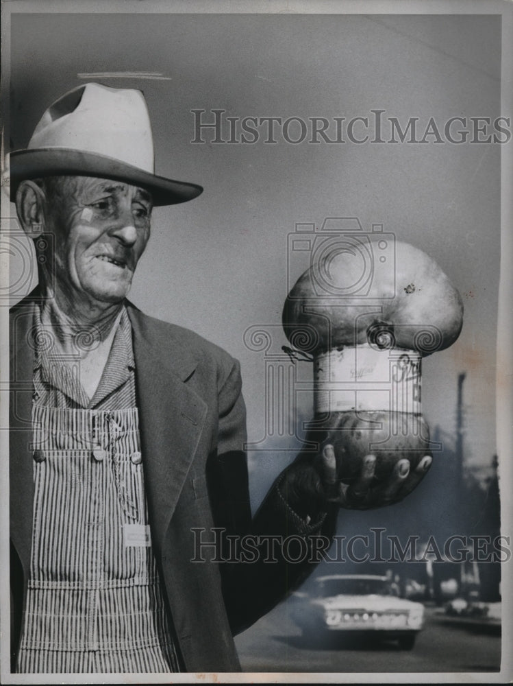 1960 Press Photo Farmer Ben Jackson Displays Pumpkin That Growing In Coffee Can- Historic Images