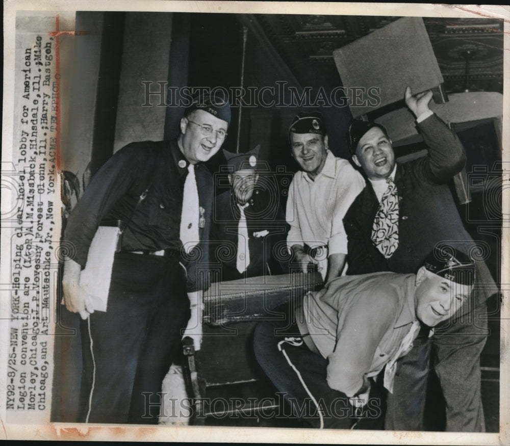 1947 Press Photo Helping clear hotel lobby for American Legion Convention. - Historic Images