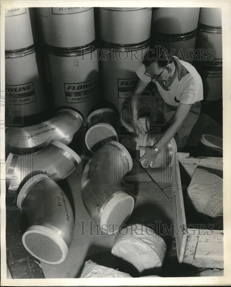 Load image into Gallery viewer, 1960 Press Photo 205 pound stainless steel elbows made by Flowline Corp
