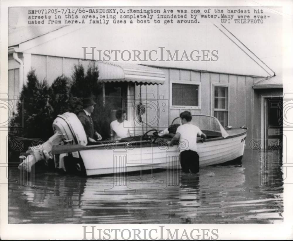 1966 Press Photo Family uses a boat to get around flooded 
Sandusky, Ohio- Historic Images