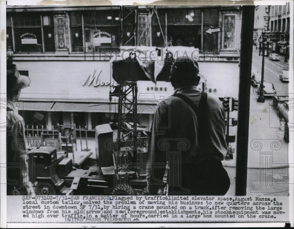 1955 Press Photo San Francisco, August Manza using crane to move his business