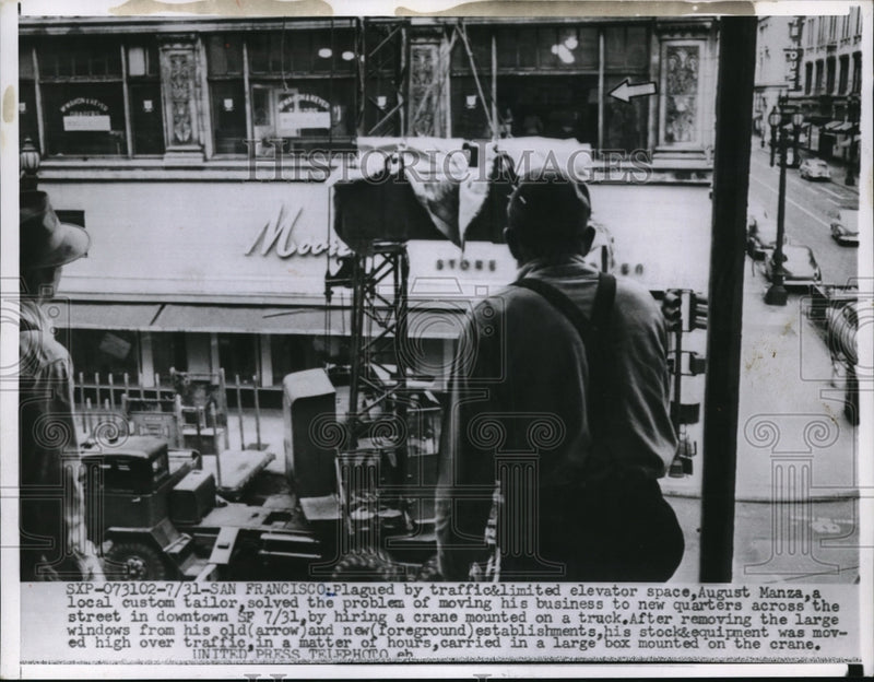 Load image into Gallery viewer, 1955 Press Photo San Francisco, August Manza using crane to move his business
