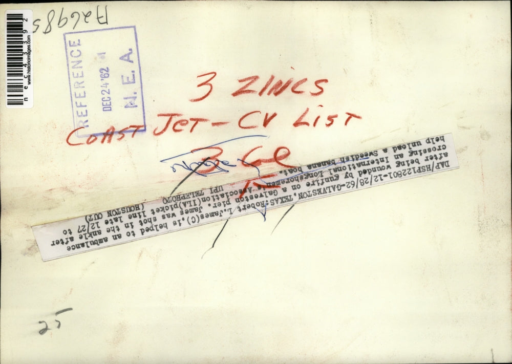 1962 Press Photo Robert L. James helped to an ambulance after being wounded.