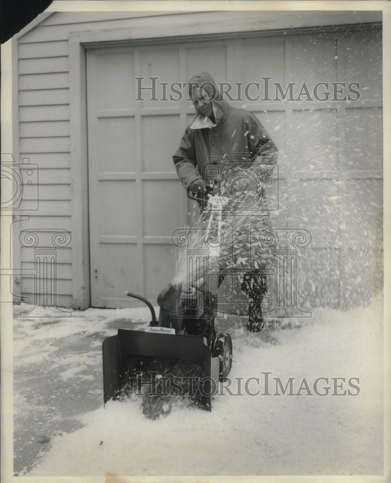 Load image into Gallery viewer, 1959 Press Photo Man using snow blower to clear homes driveway
