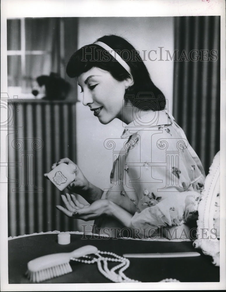 1956 Press Photo Model Shows Liquid Cream Makeup Application - nec47223