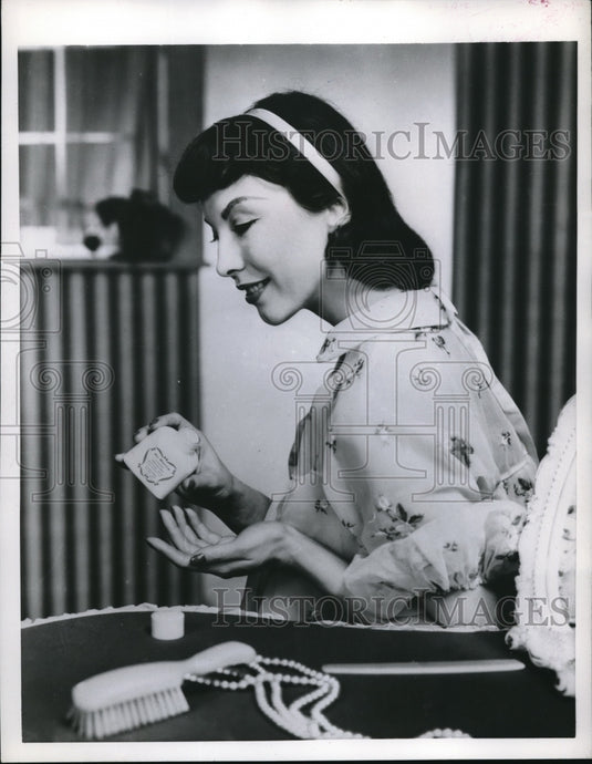 1956 Press Photo Model Shows Liquid Cream Makeup Application - nec47223