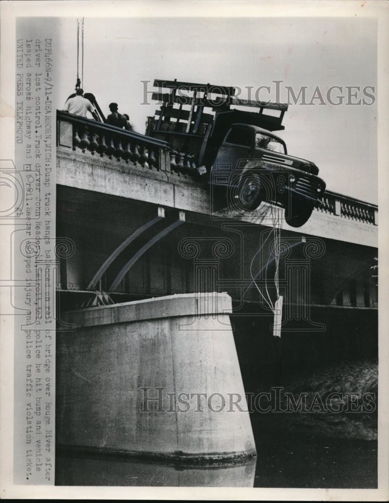 1952 Press Photo A dump truck hangs on a rail of a bridge over Rouge River