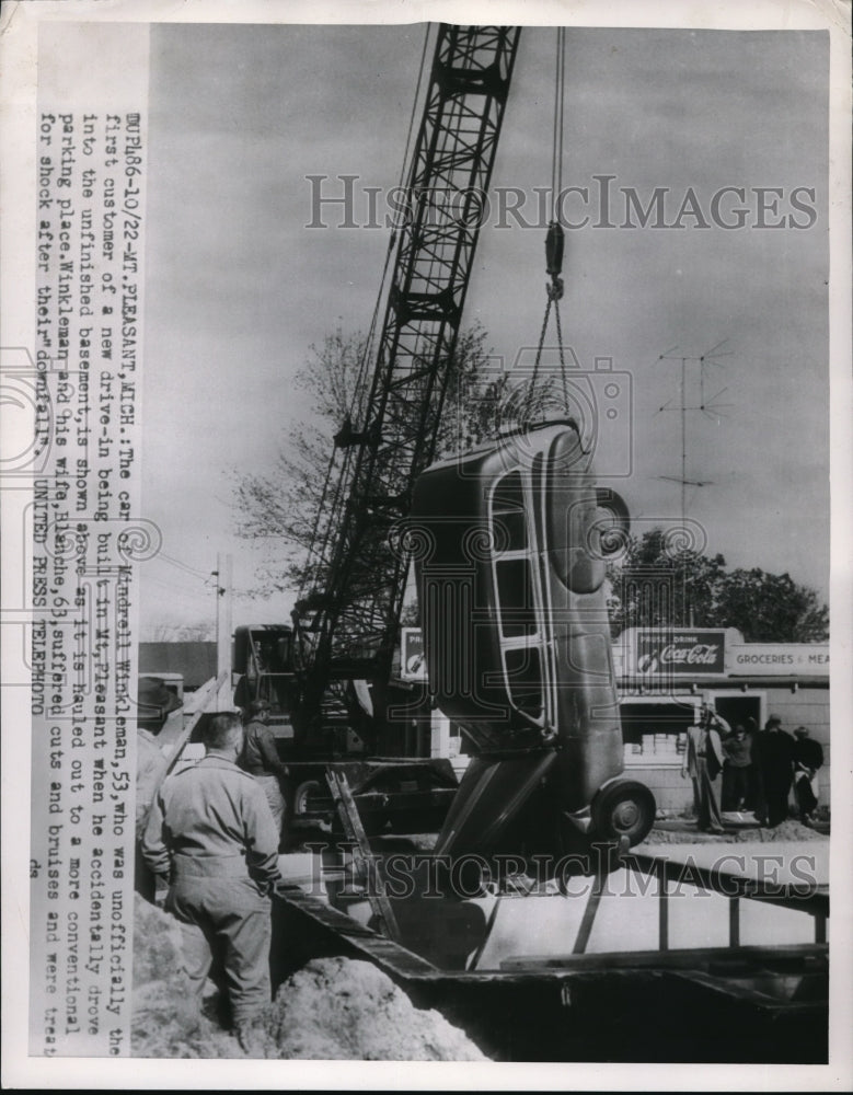 1954 Press Photo A car hauled out from unfinished basement of new drive-in