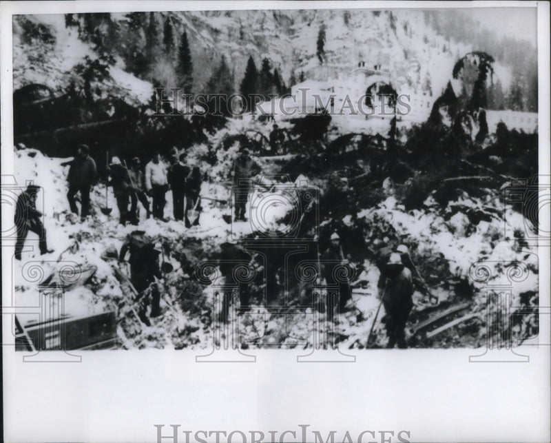Load image into Gallery viewer, 1970 Press Photo Rescue workers dig through rubble due to a avalanche

