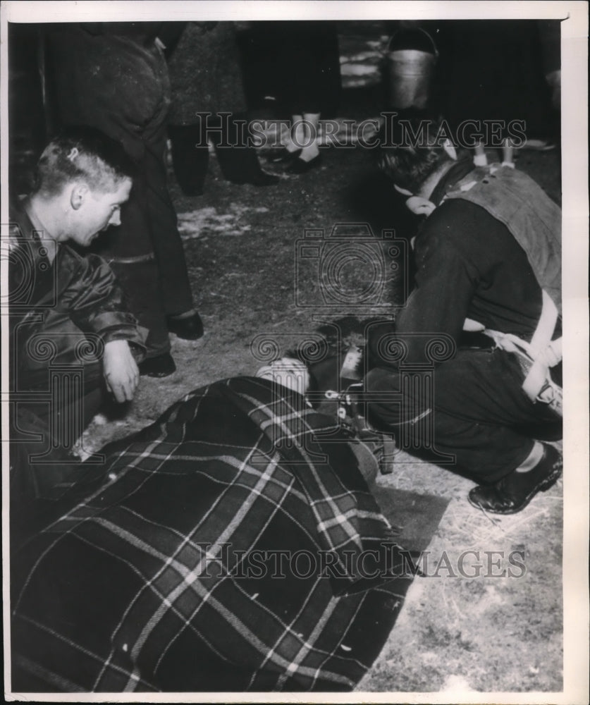 1951 Press Photo First Aide Given to Man Aboard B-25 Bomber That Crashed