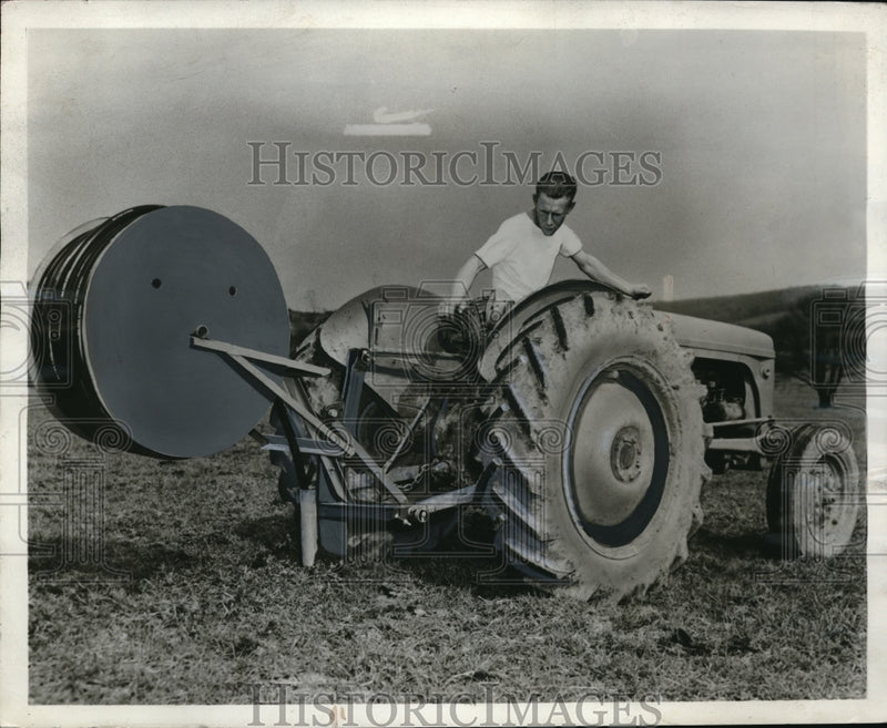 Load image into Gallery viewer, 1955 Press Photo Farmer Stands With Pipe Layer Tractor Hitch
