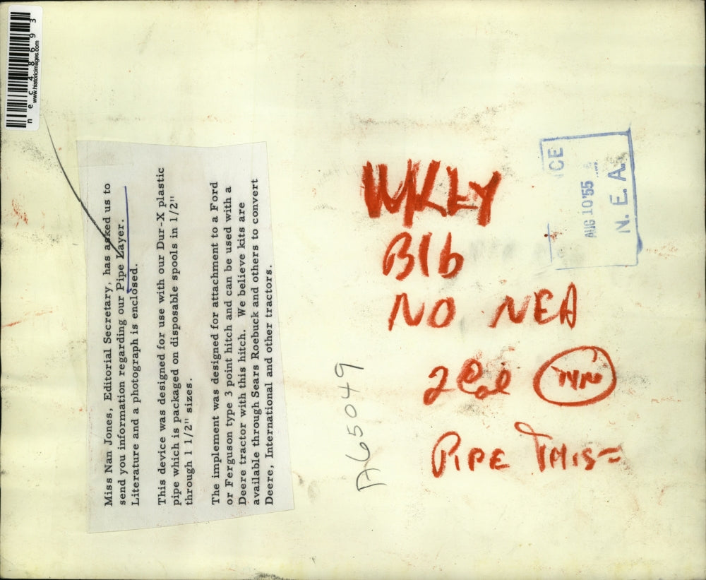 1955 Press Photo Farmer Stands With Pipe Layer Tractor Hitch