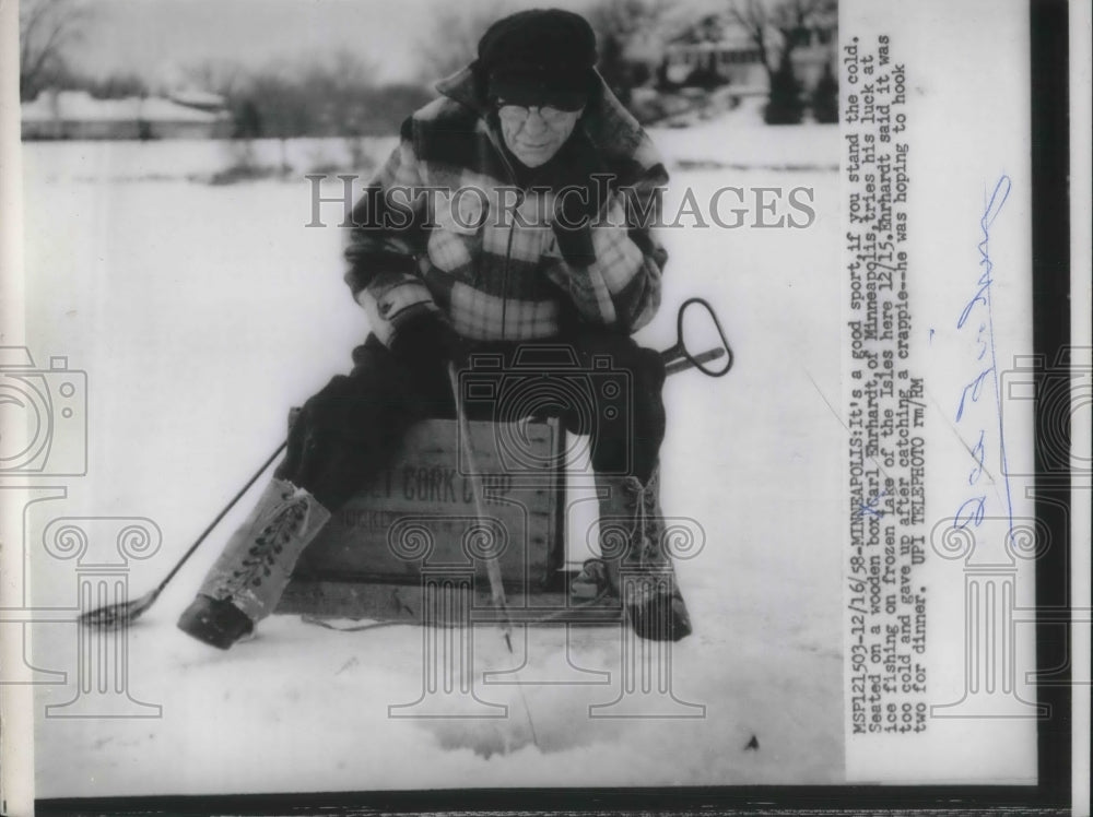 1958 Press Photo Carl Ehrhardt, ice fishing at Lake of the Isles at Minneapolis