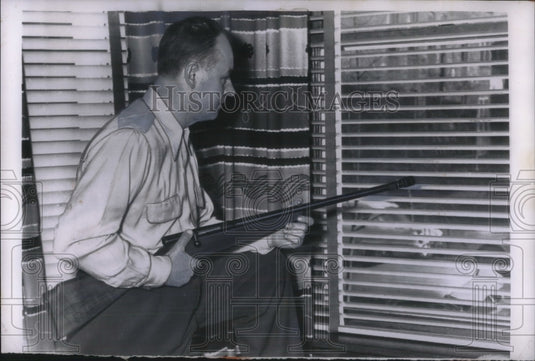 1956 Press Photo Stephen Steven stands guard in his home from "wolf pack" gang