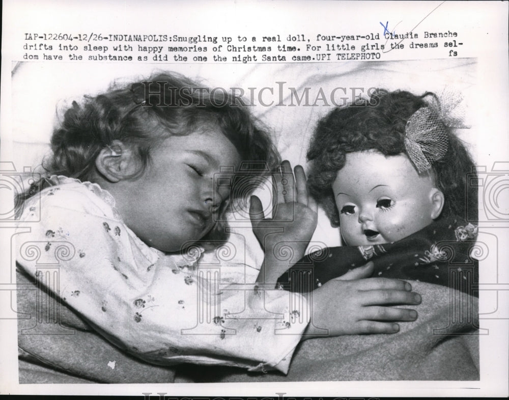 1959 Press Photo Claudia Branche cuddles up to a doll. Indianapolis Indiana