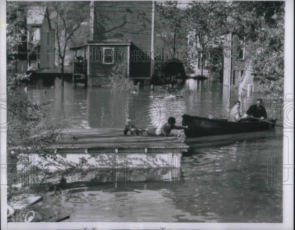 1954 Press Photo Wheeling W VA flood victim is rescued by boat from top of house- Historic Images