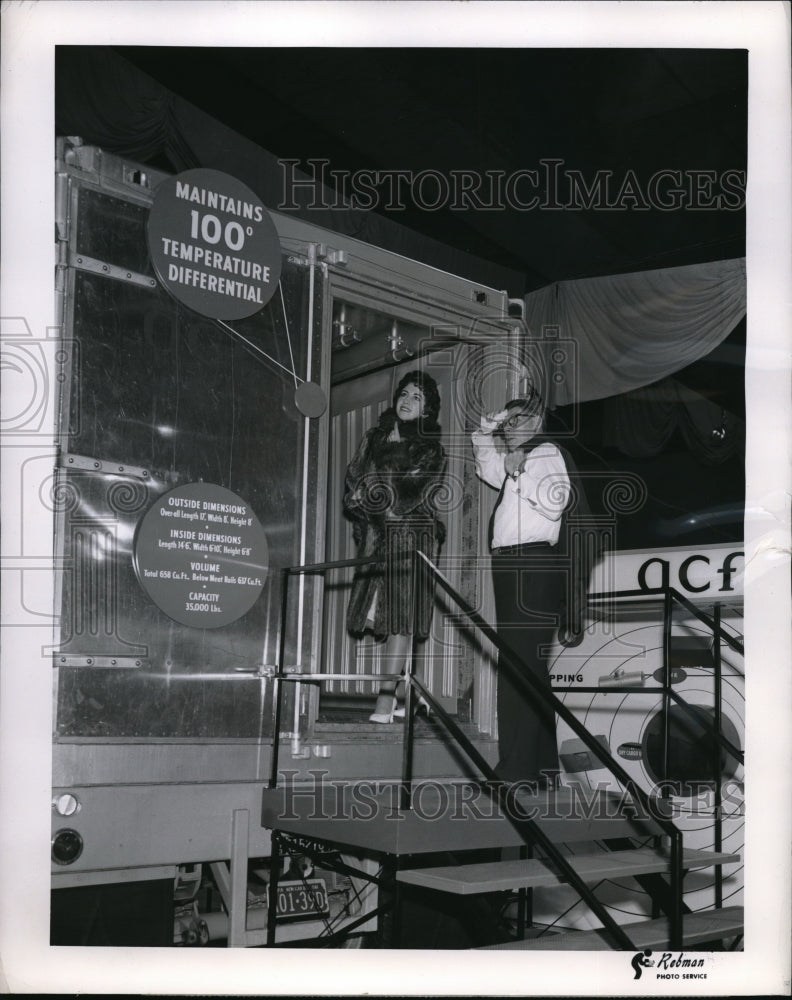 Load image into Gallery viewer, 1958 Press Photo Betty Jean Miller wearing racoon coat enters cold cargo
