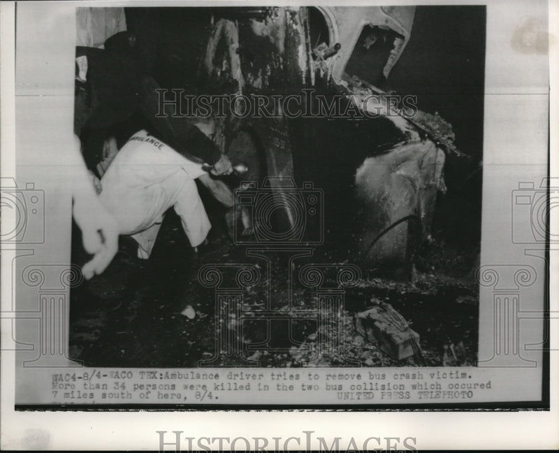 Load image into Gallery viewer, 1952 Press Photo Ambulance driver tries to remove bus crash victim.
