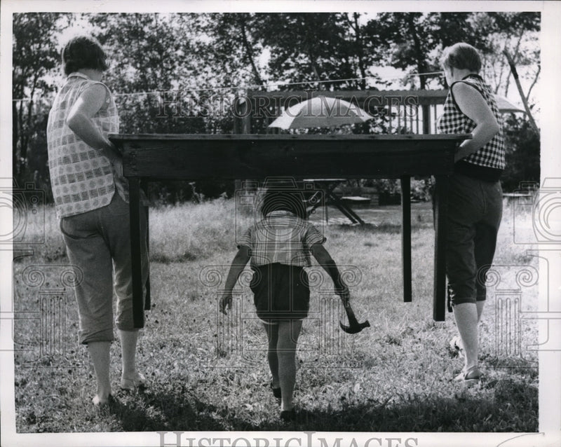 Load image into Gallery viewer, 1957 Press Photo Carrying Table in preparation for Weenie Roast Outdoor Picnic.
