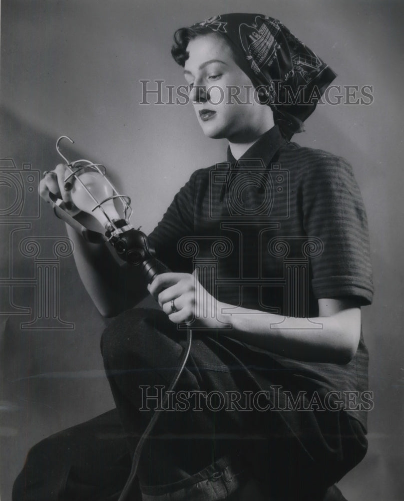 1951 Press Photo A better bulb for defense holding by this women - nec59272