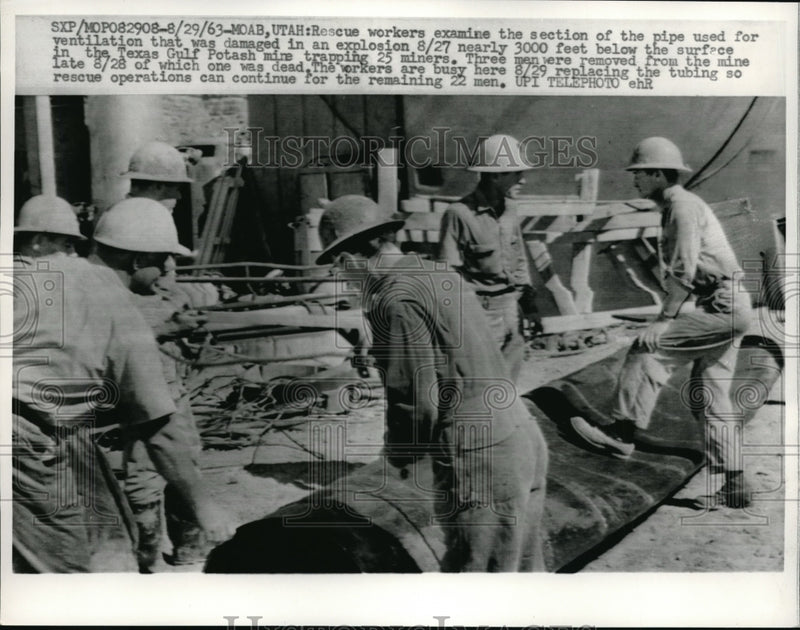Load image into Gallery viewer, 1963 Press Photo Rescue Workers examine pipe used for ventilation that was damaged in explosion at T
