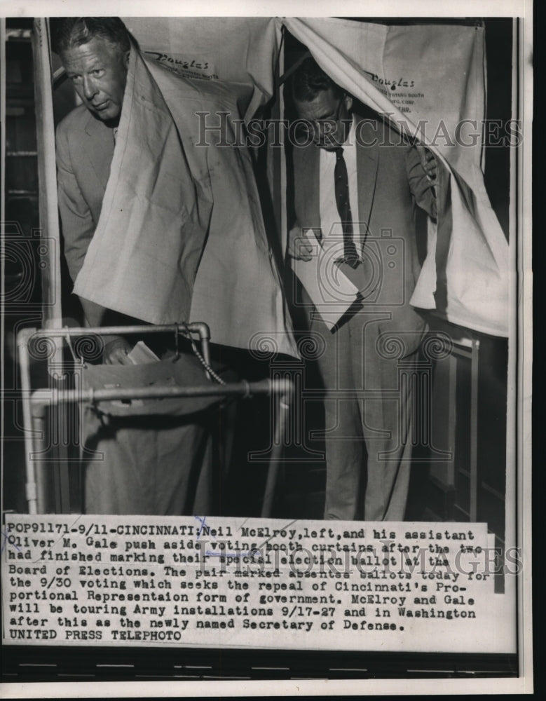 Load image into Gallery viewer, 1957 Press Photo Neil McElroy, assistant Oliver Gale, casting their special election ballot
