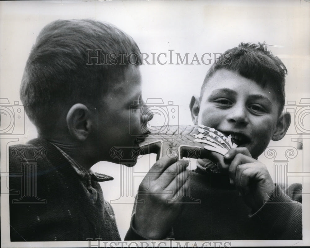1959 Press Photo Parisian Boys Eat Gingerbread Pig - nec65962